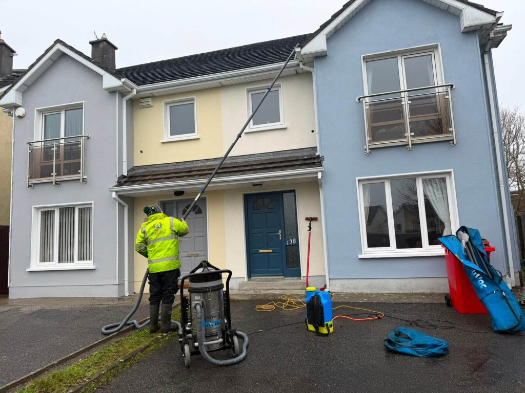man with gutter vac